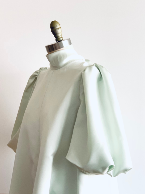 Sleeve view of cool mint green satin smock dress by the lotus bloom co.