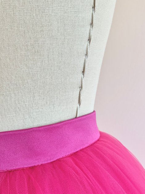 Close-up of waistband of fuchsia pink asymmetrical tulle skirt by the lotus bloom co