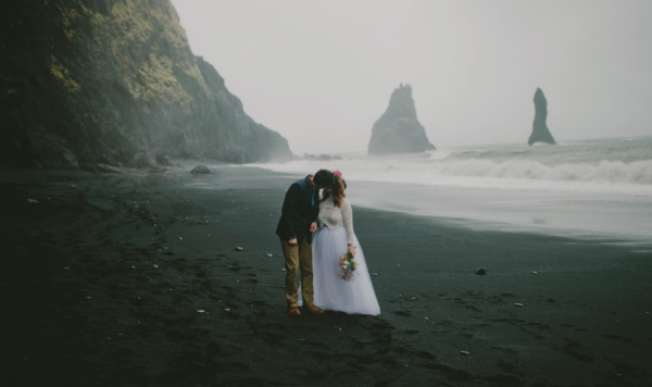 Elopement couple on Icelandic beach, bride wearing an ivory tulle maxi skirt by the lotus bloom co.